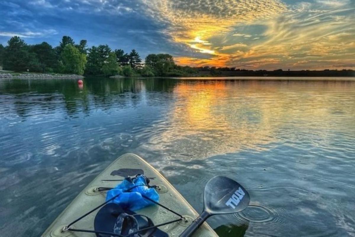 kayak on a lake at sunset