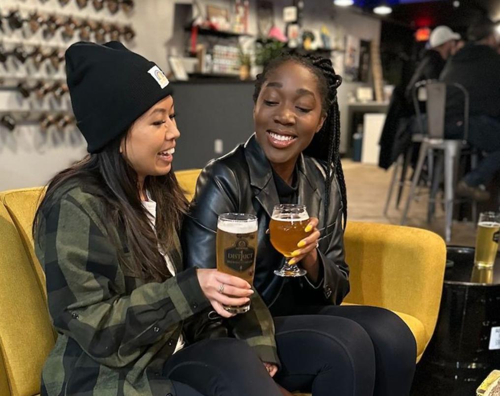 Two friends grabbing drinks at District 1 Brewing.