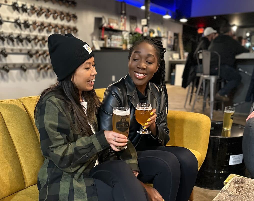 Two friends grabbing drinks at District 1 Brewing.