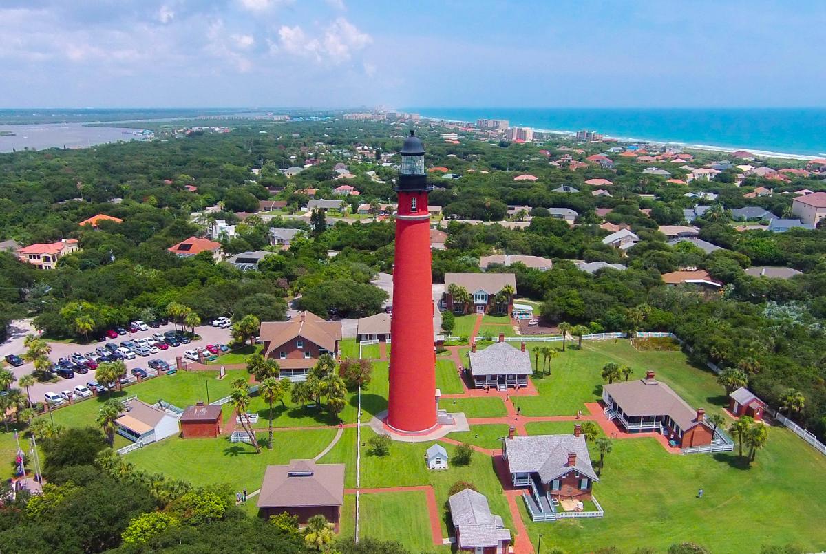 An aerial view of Ponce Inlet Lighthouse shows the inland waterway and the Atlantic Ocean