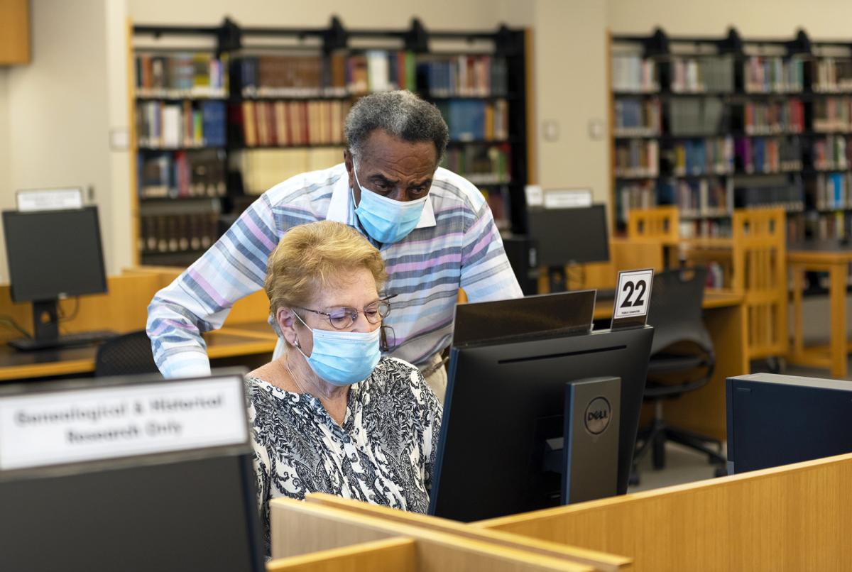 Two adults wearing a mask researching in the Genealogy Center in Fort Wayne, Indiana