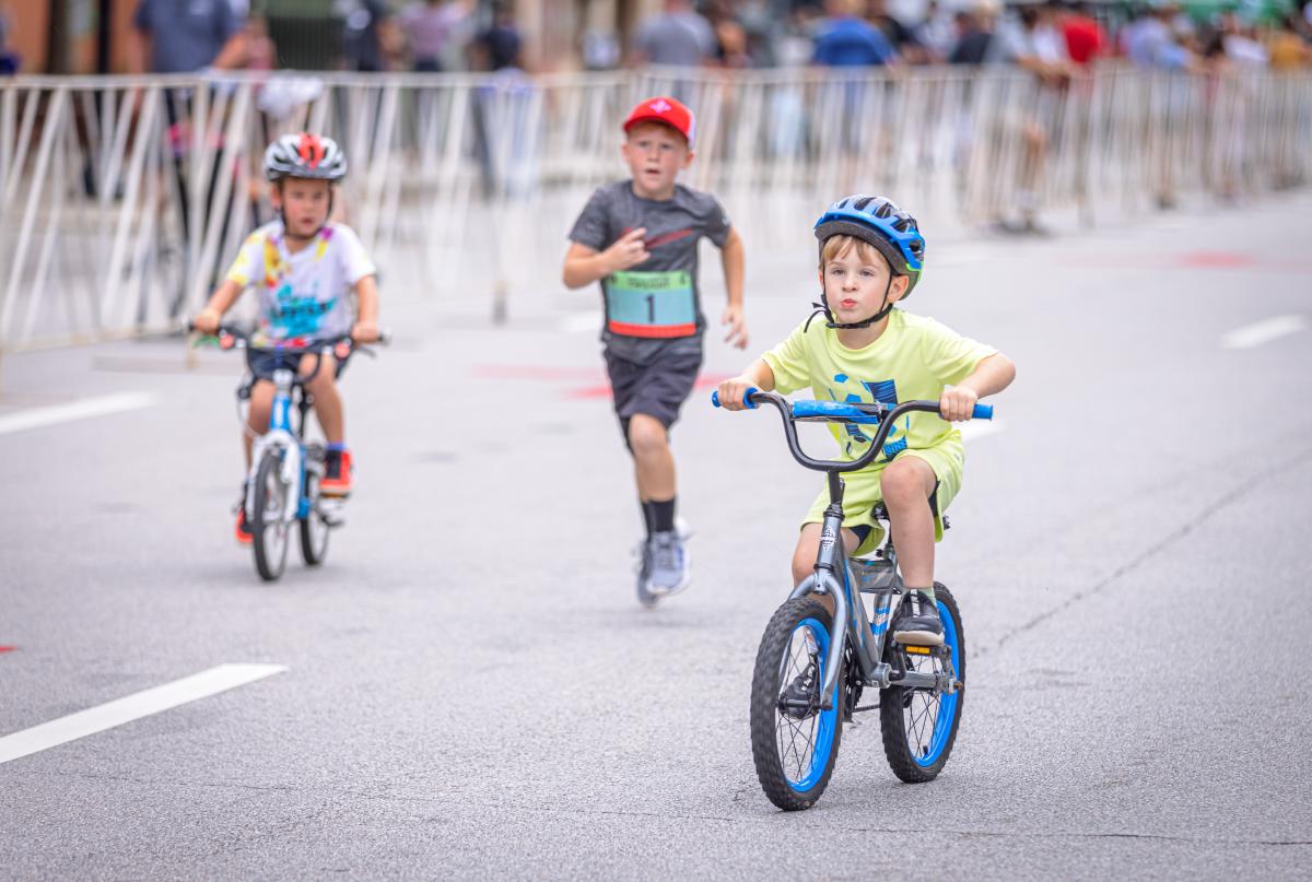 three children in a race, two on bikes