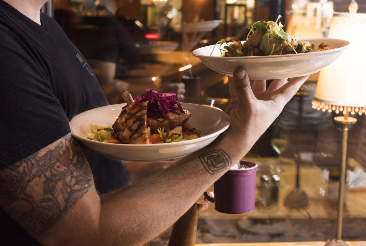 Waiter Carrying food at Mona Lisa's Downtown Eau Claire