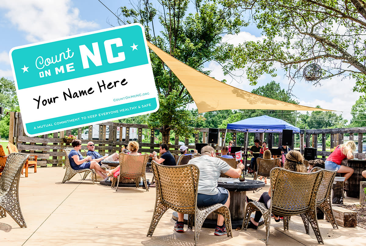 Photo of the Double Barley beer garden with blue sky and sunshine with an overlay of a name badge from the Count On Me NC guest promise initiative.