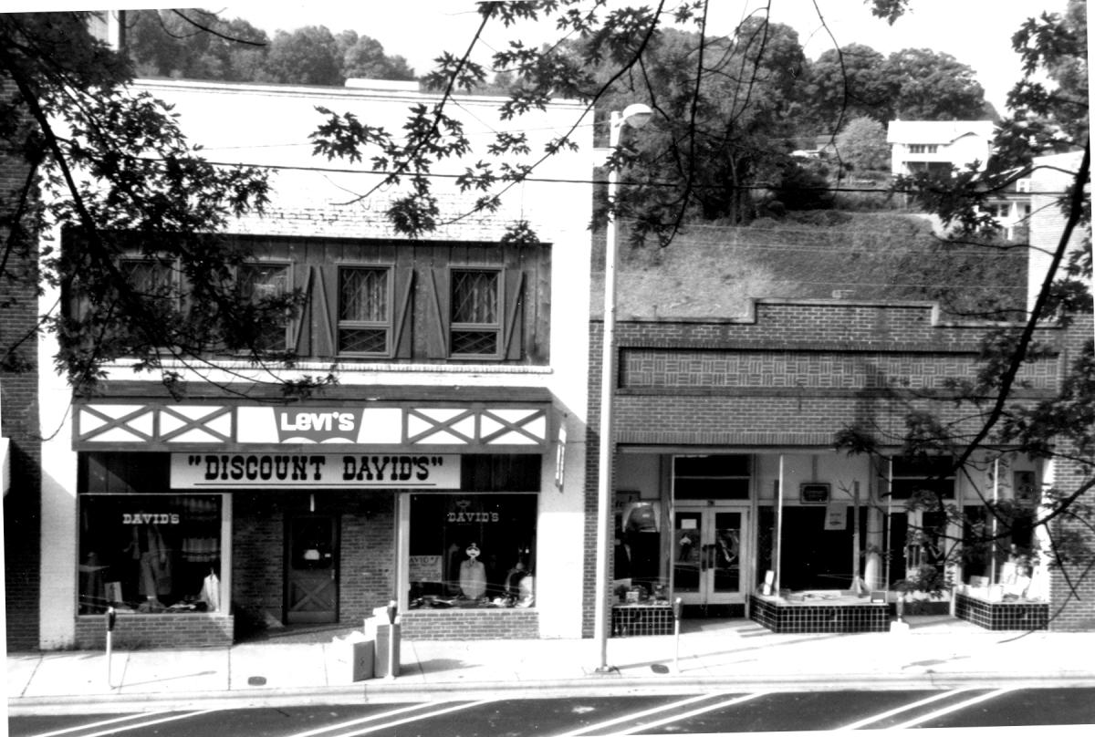 Discount David’s clothing store with a Levi’s sign and Tudor-style trim next to a brick storefront on Main Street in Sylva, NC