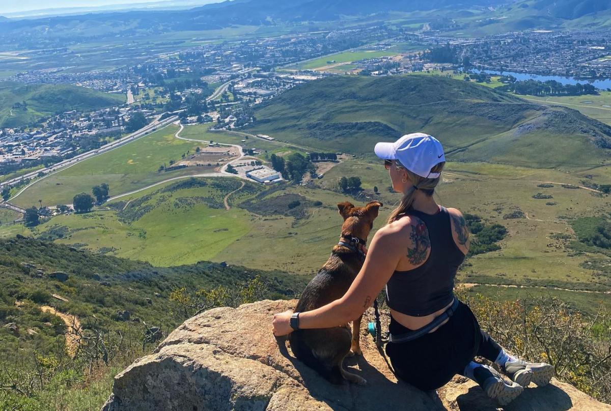 woman hiking with her dog