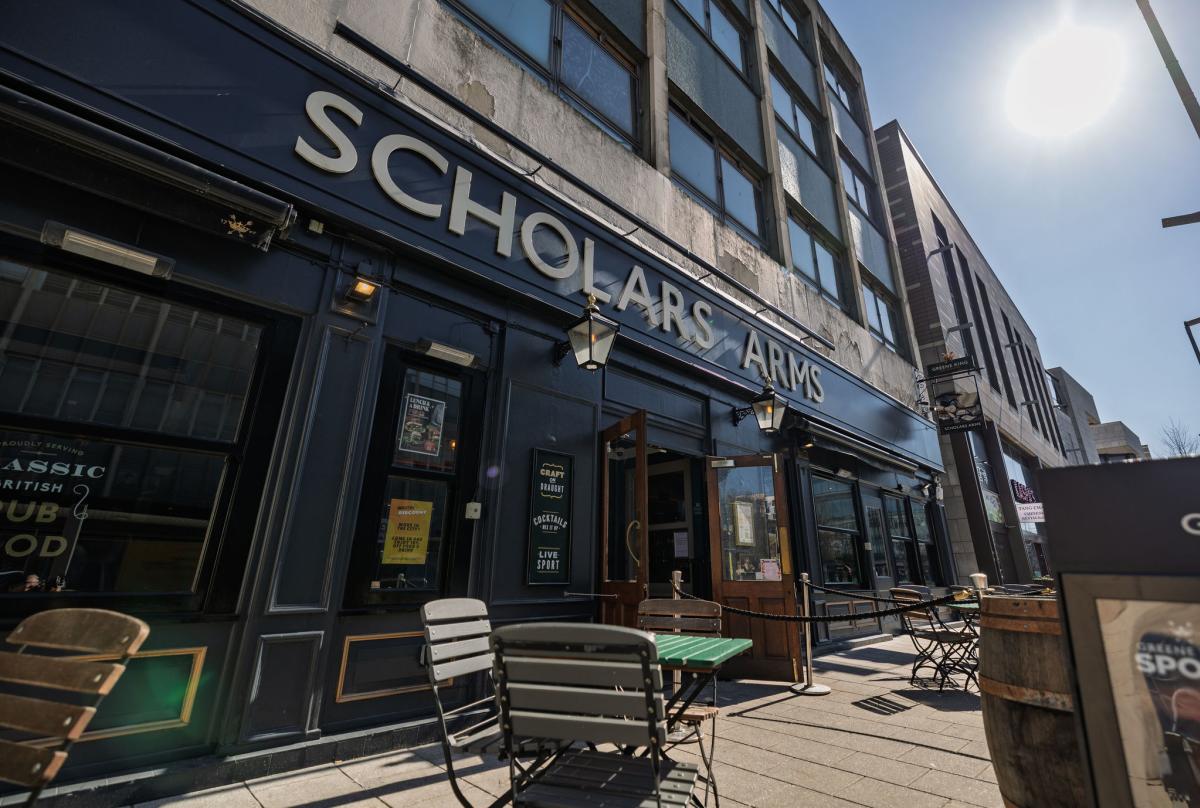 Outside of Scholars Arms pub with tables and chairs on a sunny day