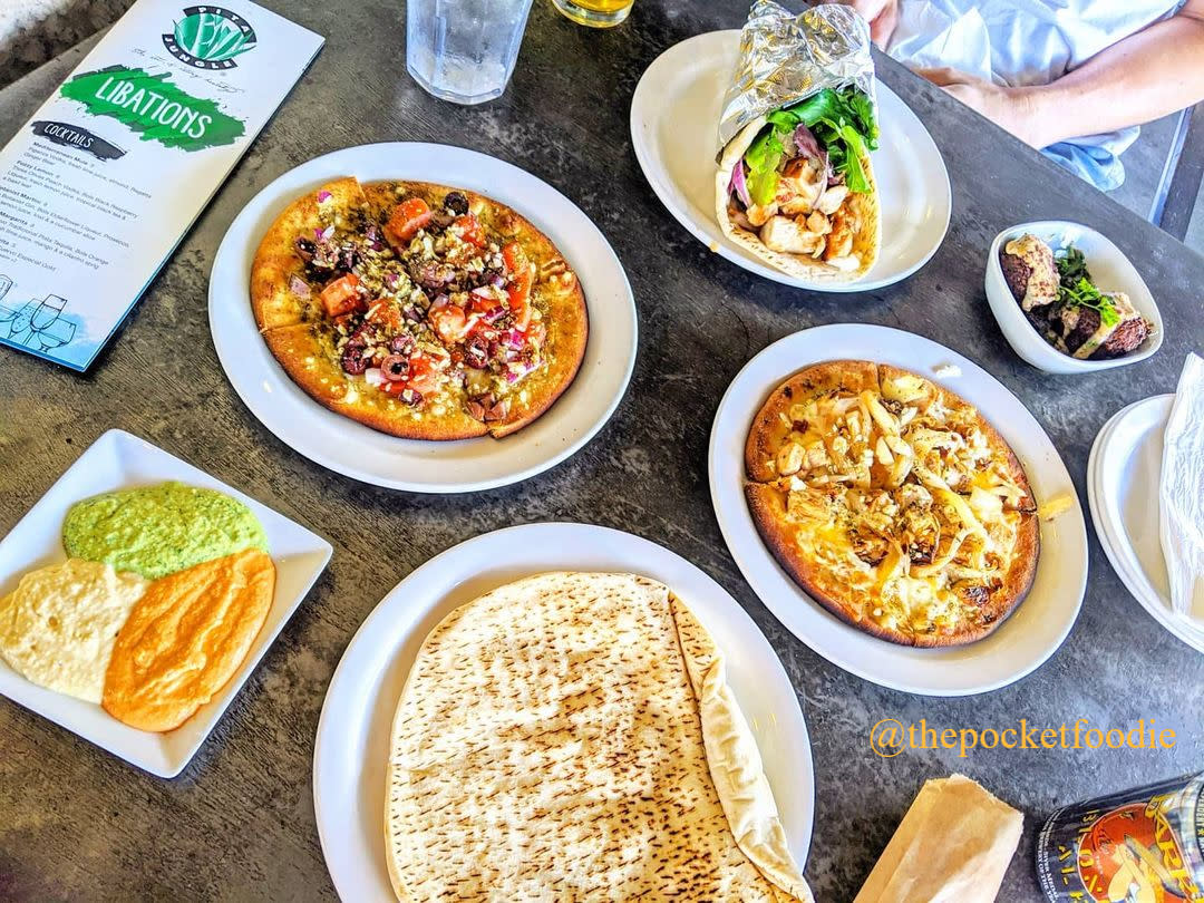 Mediterranean Tapas, hummus, pita bread and schwarma displayed on a table