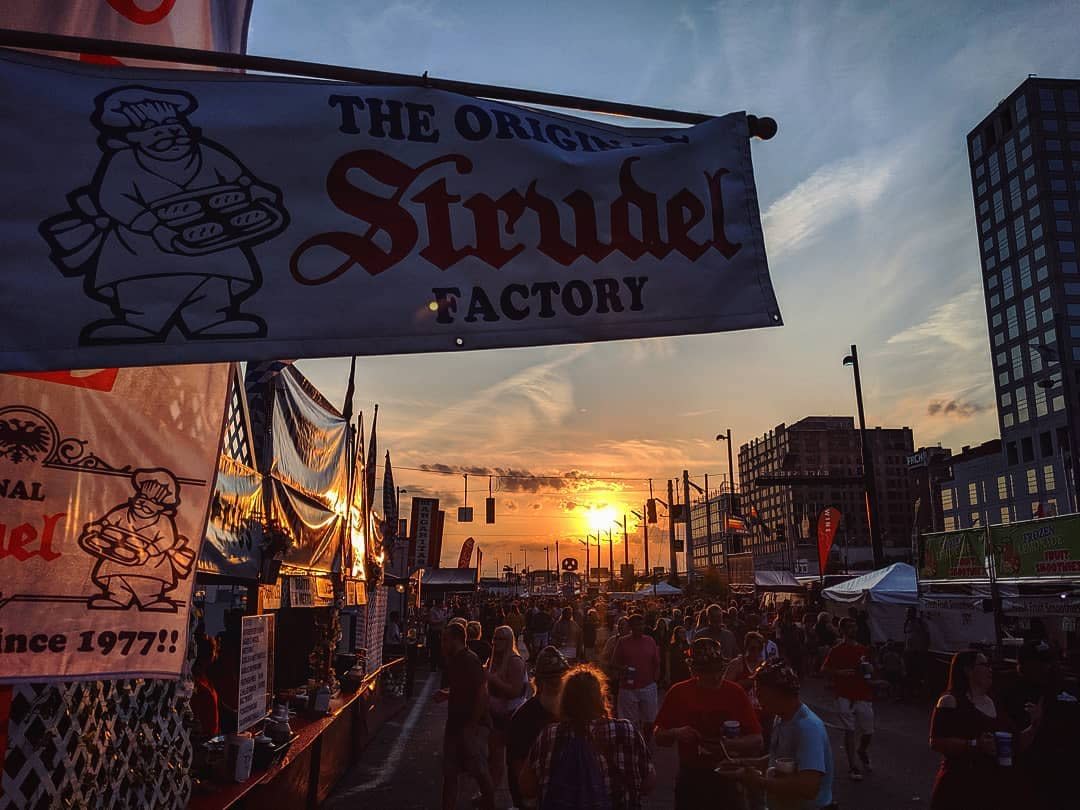 Sunset behind a banner for a Strudel booth at Oktoberfest Zinzinnati