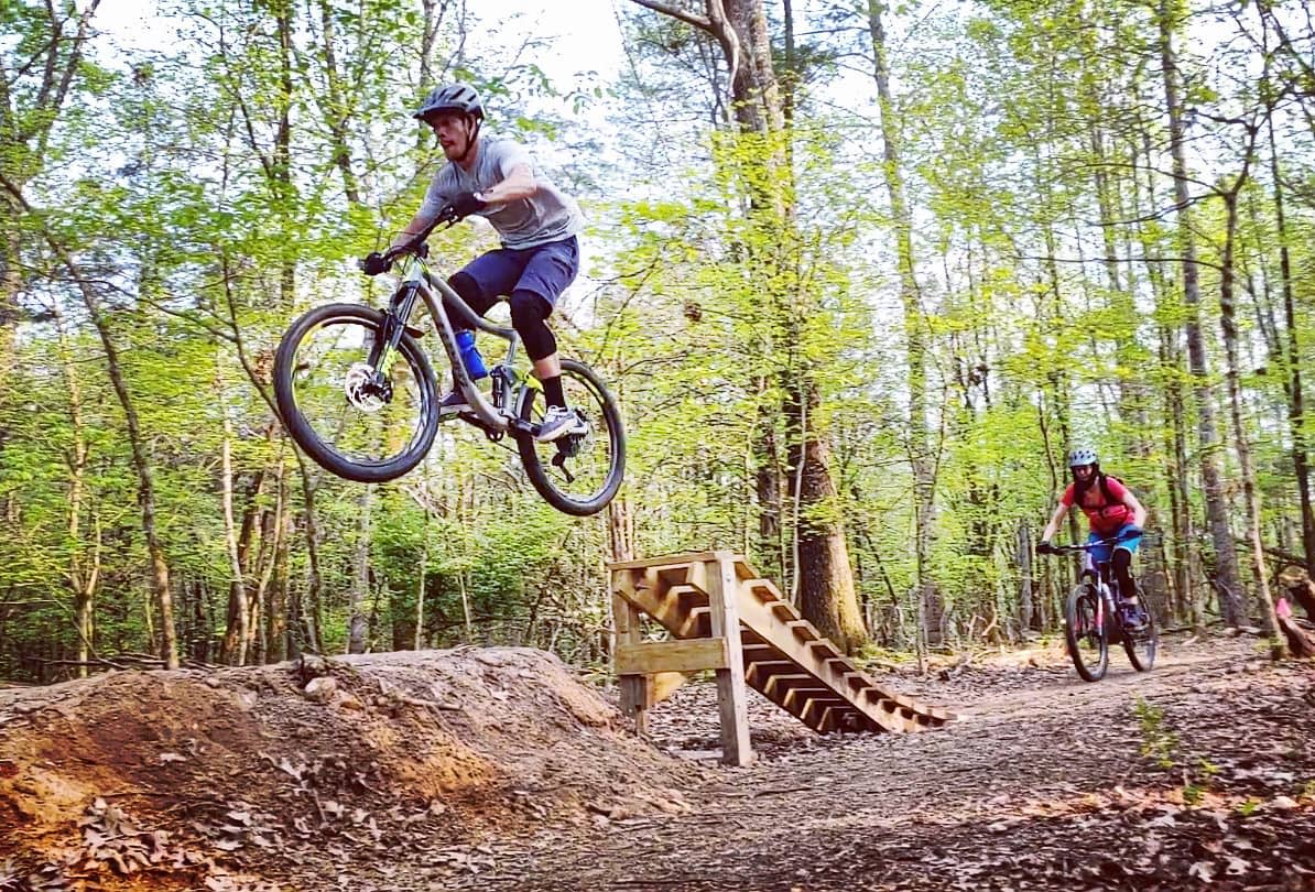 mountain bike jumping over a ramp