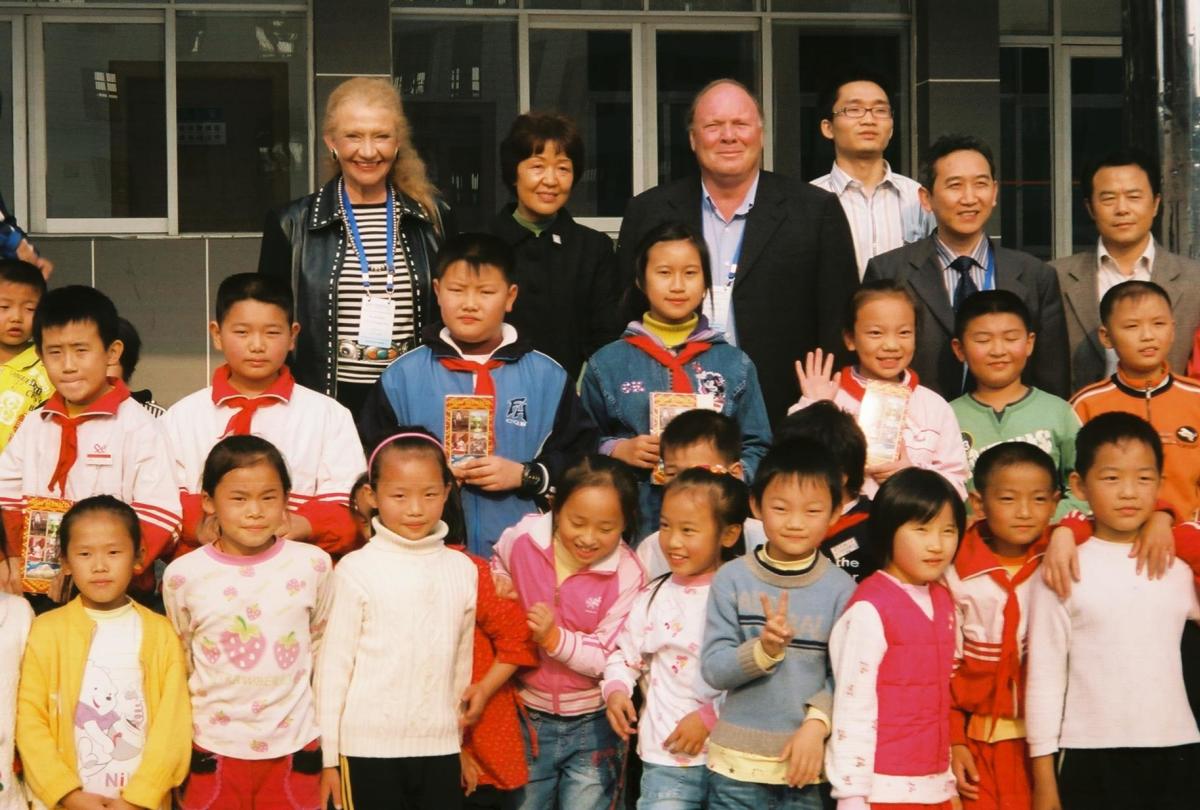 Carol Robertson Lopez, Chair of the City of Santa Fe Sister Cities Committee, and Jeff Case, Ph.D., meet with young students during a visit to Zhangjiajie.