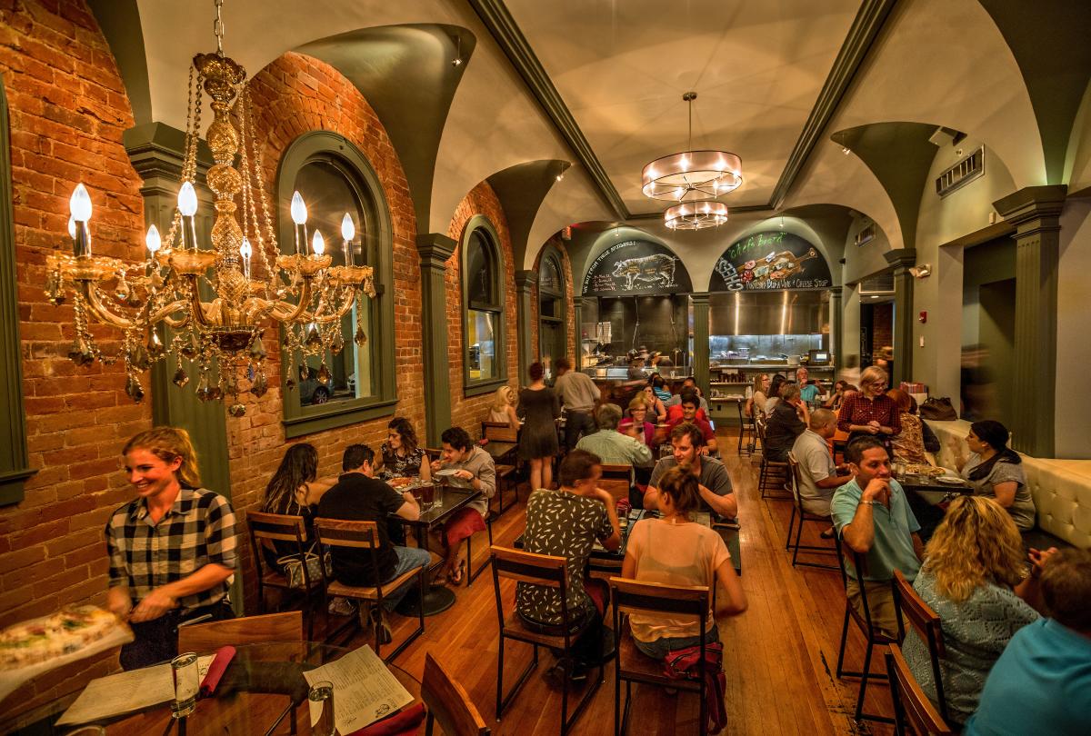 Interior of Reilly downtown with tables filled with people eating and talking