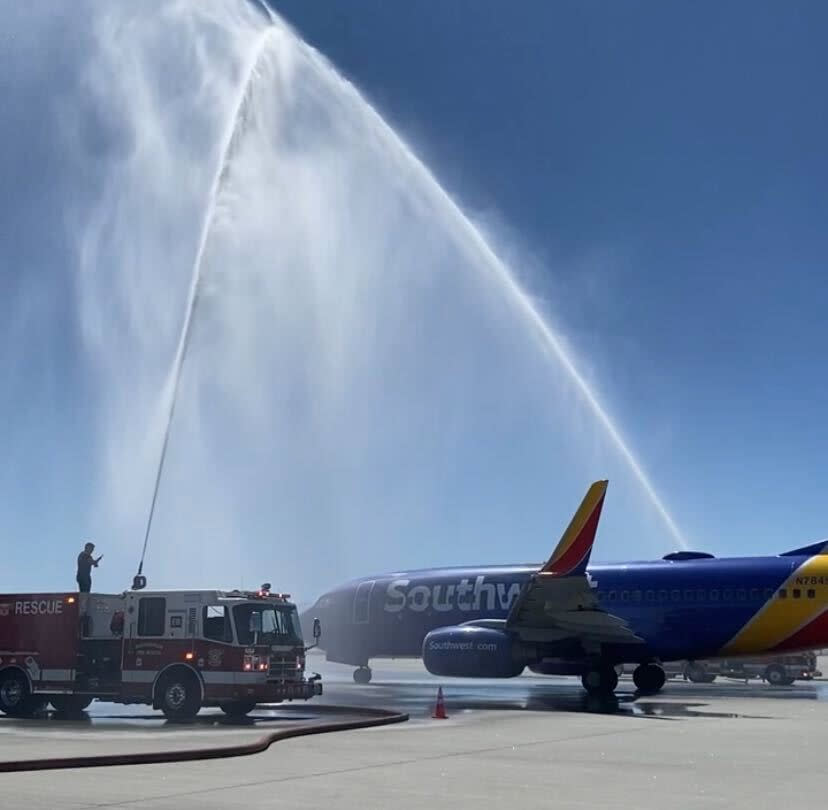 Fire trucks spray a salute to the first Southwest nonstop flight to Long Beach, California