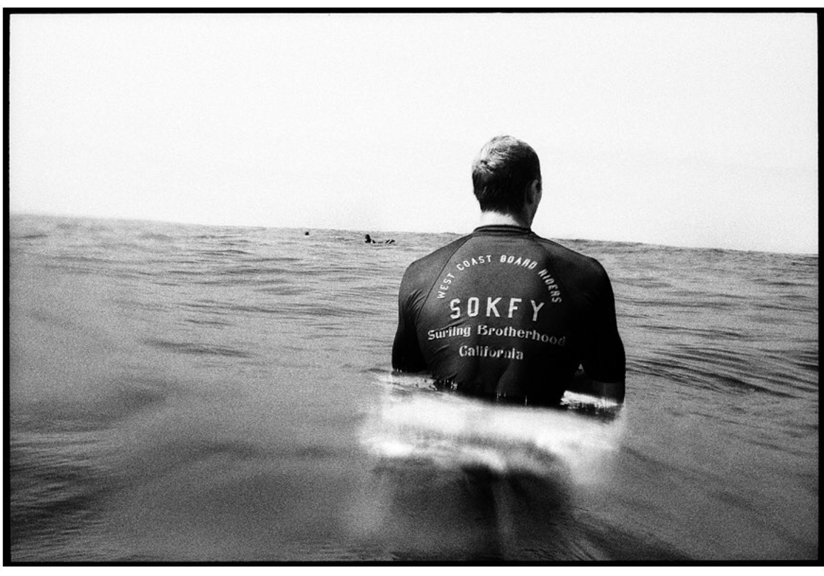 Surfer wearing West Coast Board Riders shirt made by SOKFY