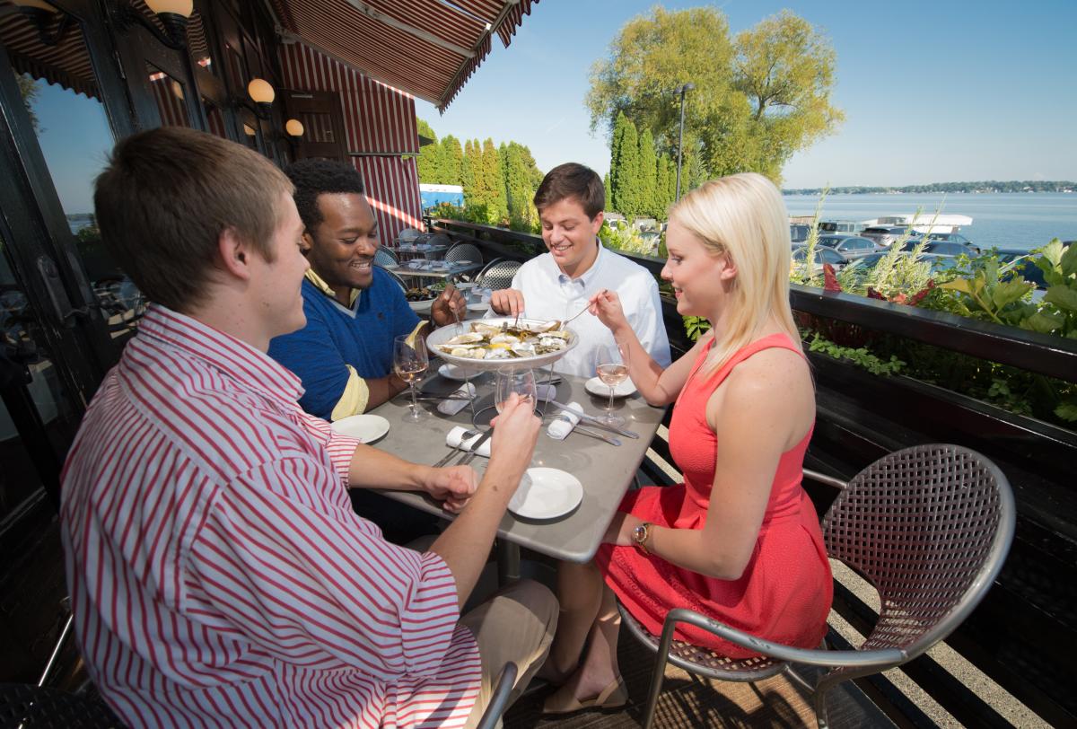 A group of friends dine on oysters at Sardine, along Lake Monona.