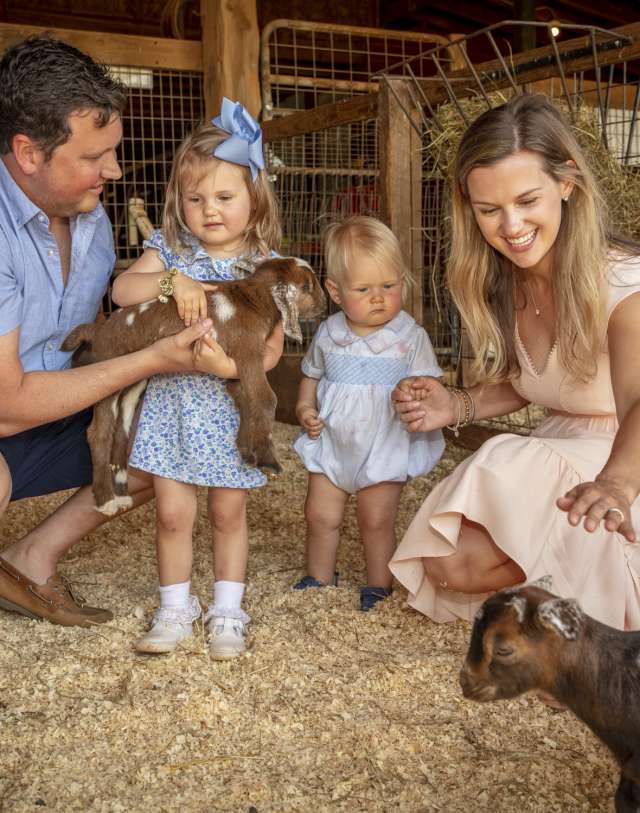 Family playing with goats