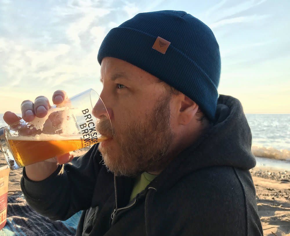 Man drinking beer on the beach