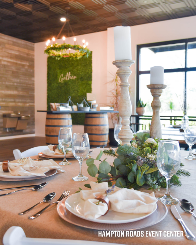 Event space is set with a table filled with plates and napkins