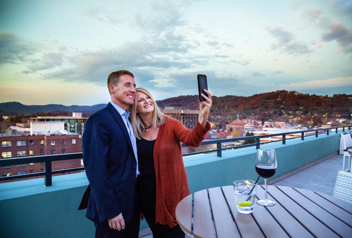 Couple Taking Selfie Photo from Rooftop Lounge in Downtown Asheville