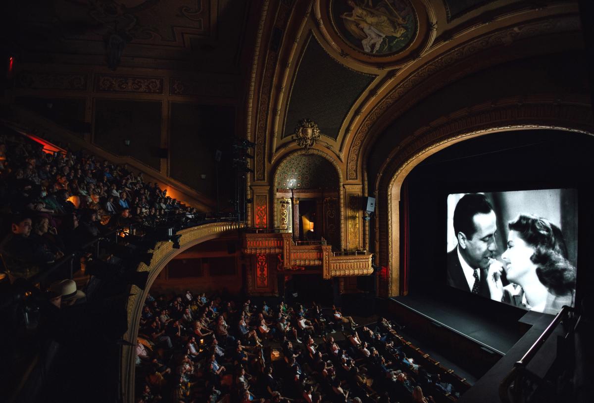 Wide-angle image of people watching a black-and-white classic film at the Paramount Theater.