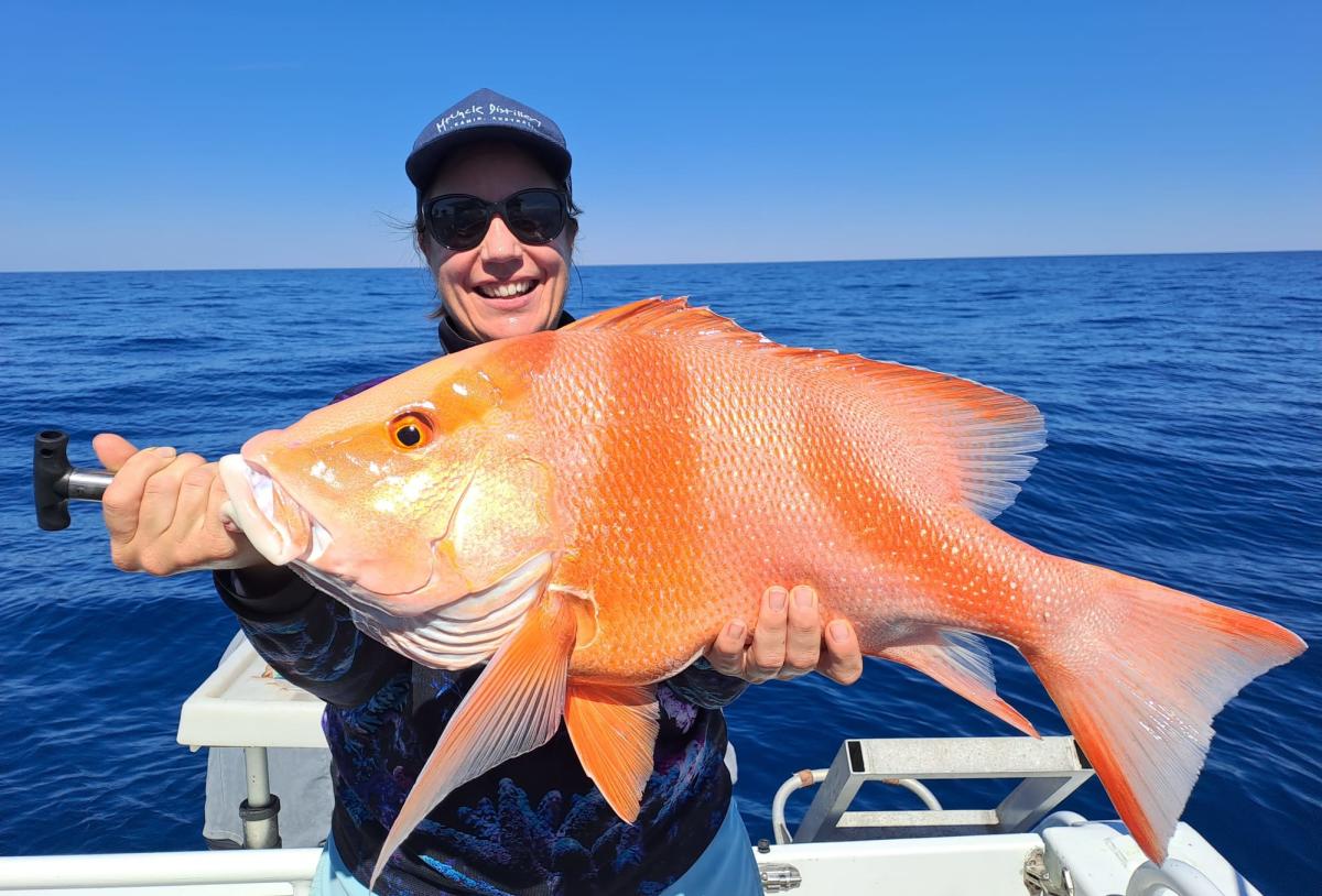 Woman holding a freshly caught Red Emperor