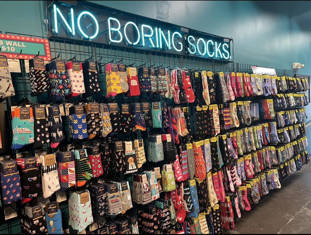 A wall of socks is on display at Sweet n saucy in WIchita.