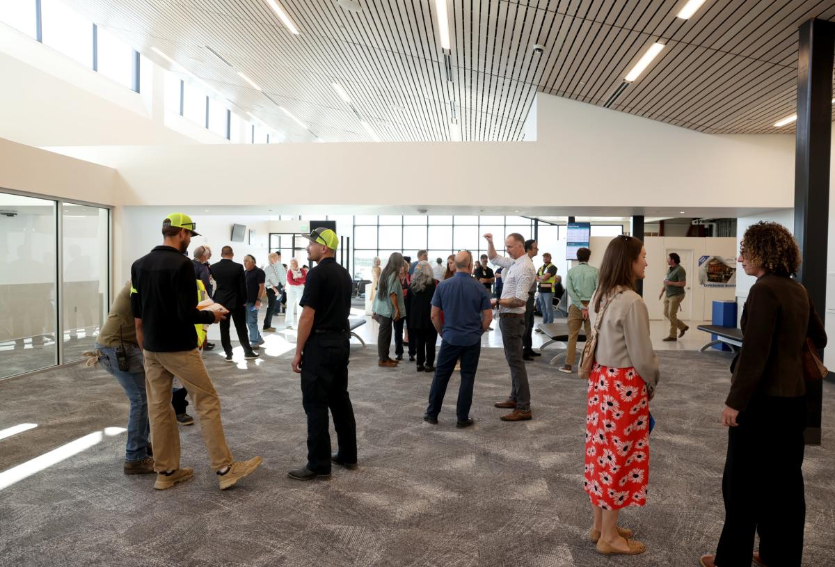 A wide of people talking in the new Durango - La Plata Country Airport terminal with its pleasant atmosphere filled with natural light.