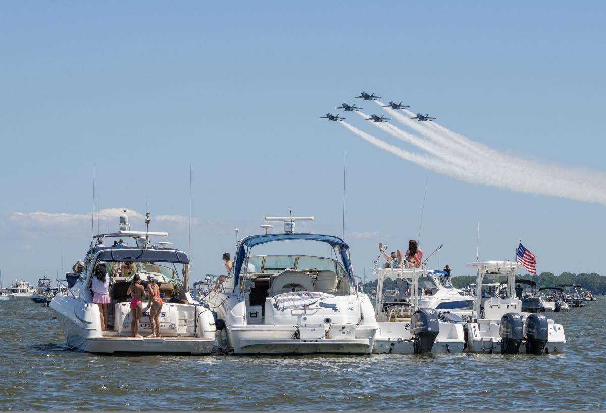Families aboard boats viewing the iconic Blue Angels along the Severn River.