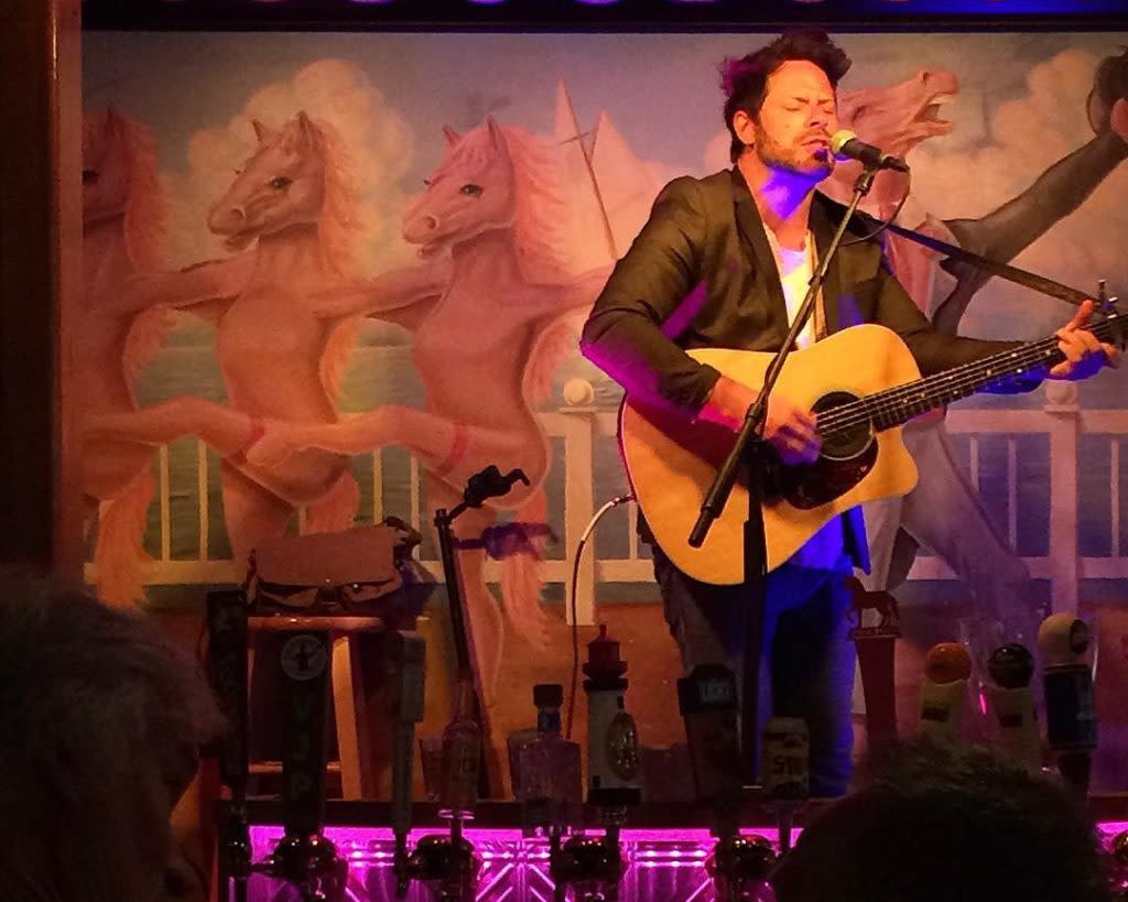 A musician plays guitar and sings in the Pink Pony on Mackinac Island