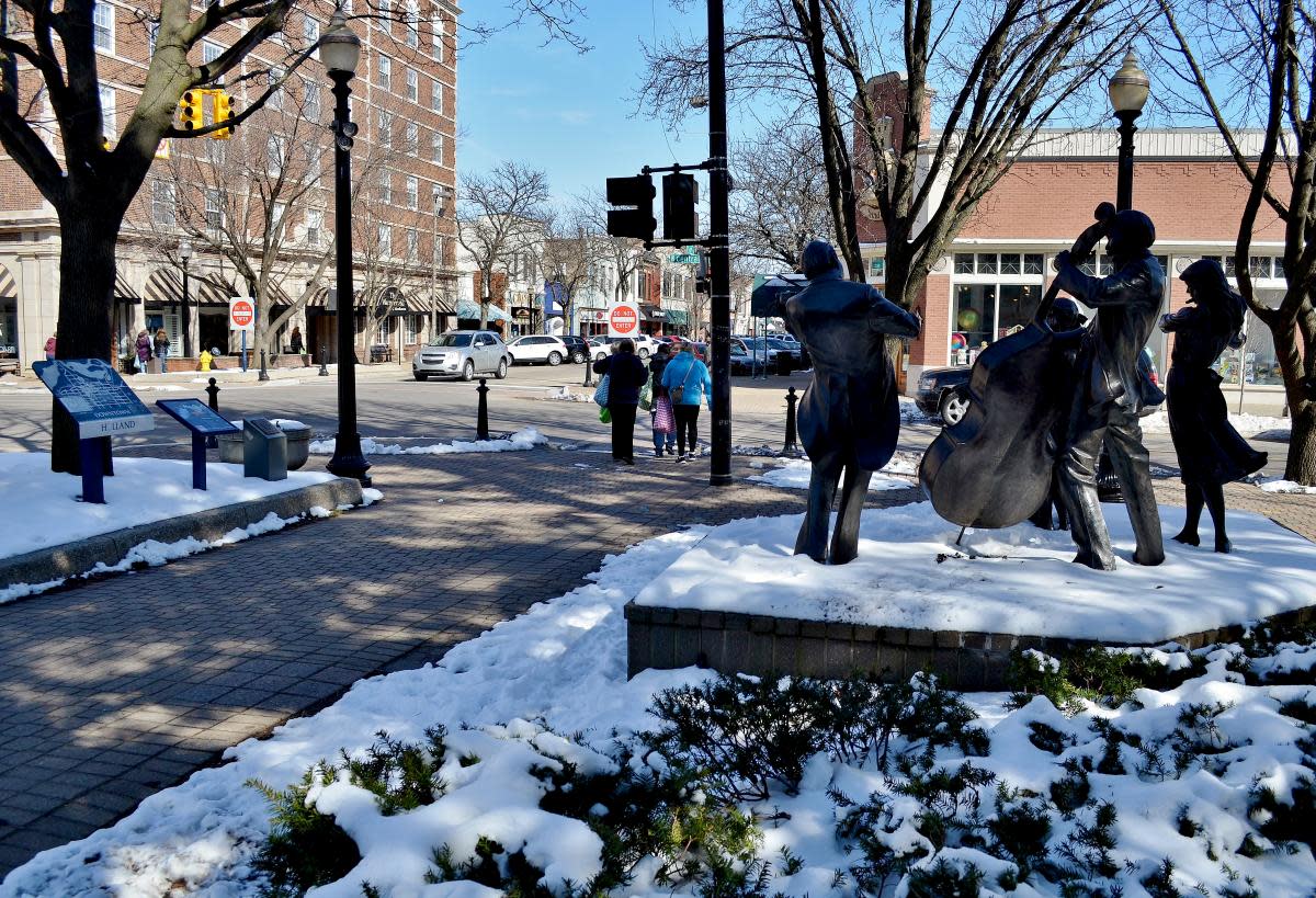 snow melt downtown street statue