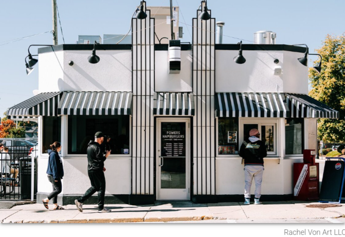 The front of Powers Hamburgers building in Fort Wayne. A small white diner with black awnings and an old timey feel.