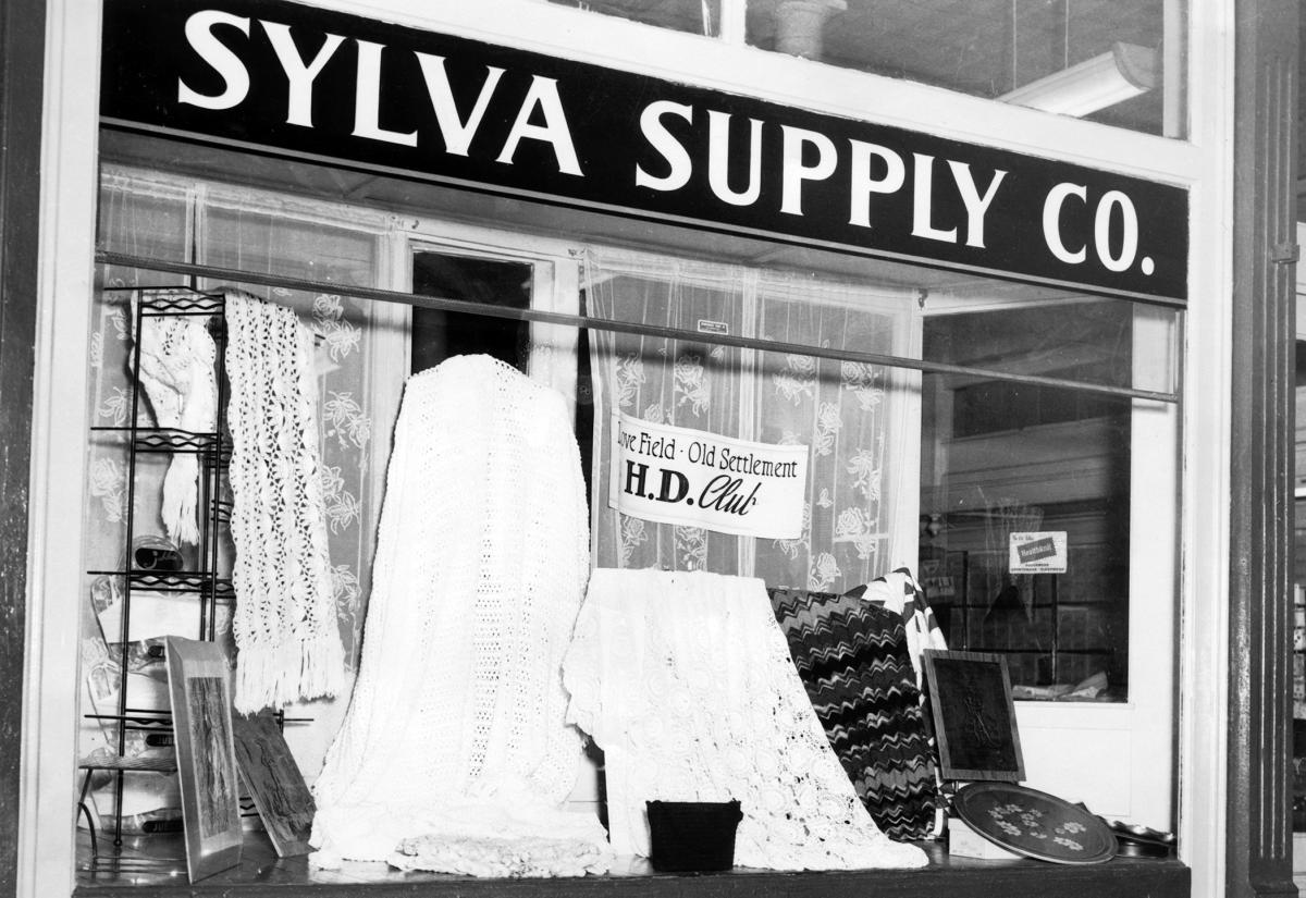 Sylva Supply Co. display window in Sylva, NC, in the 1960s, showing crocheted bedspreads, quilts and crafts by the Love Field-Old Settlement H.D. Club