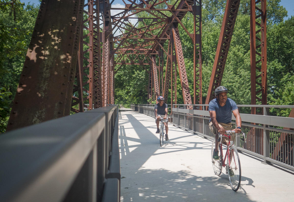 cyclist biking across a bridge