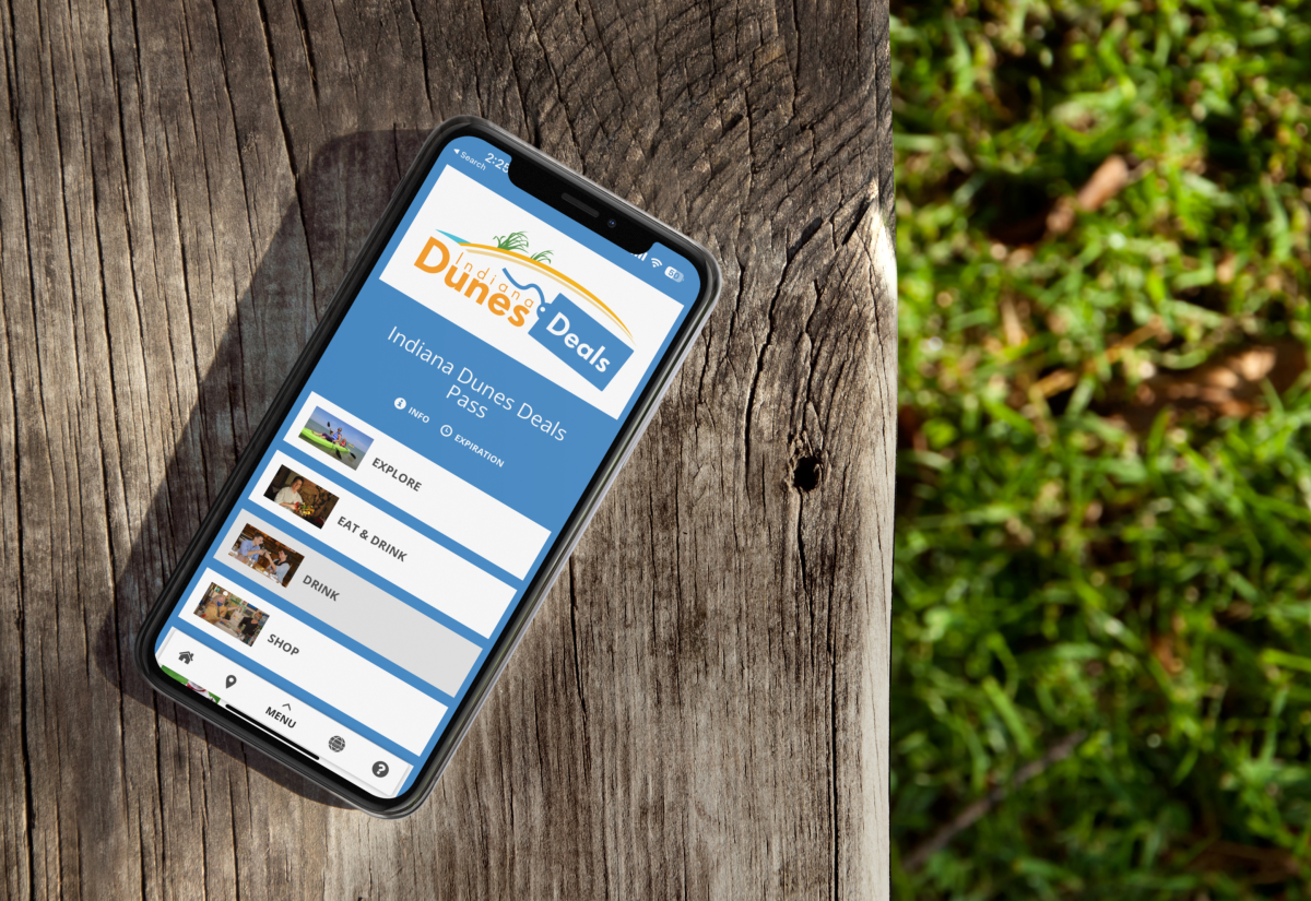 A phone sits on a wooden bench with a shopping screen open