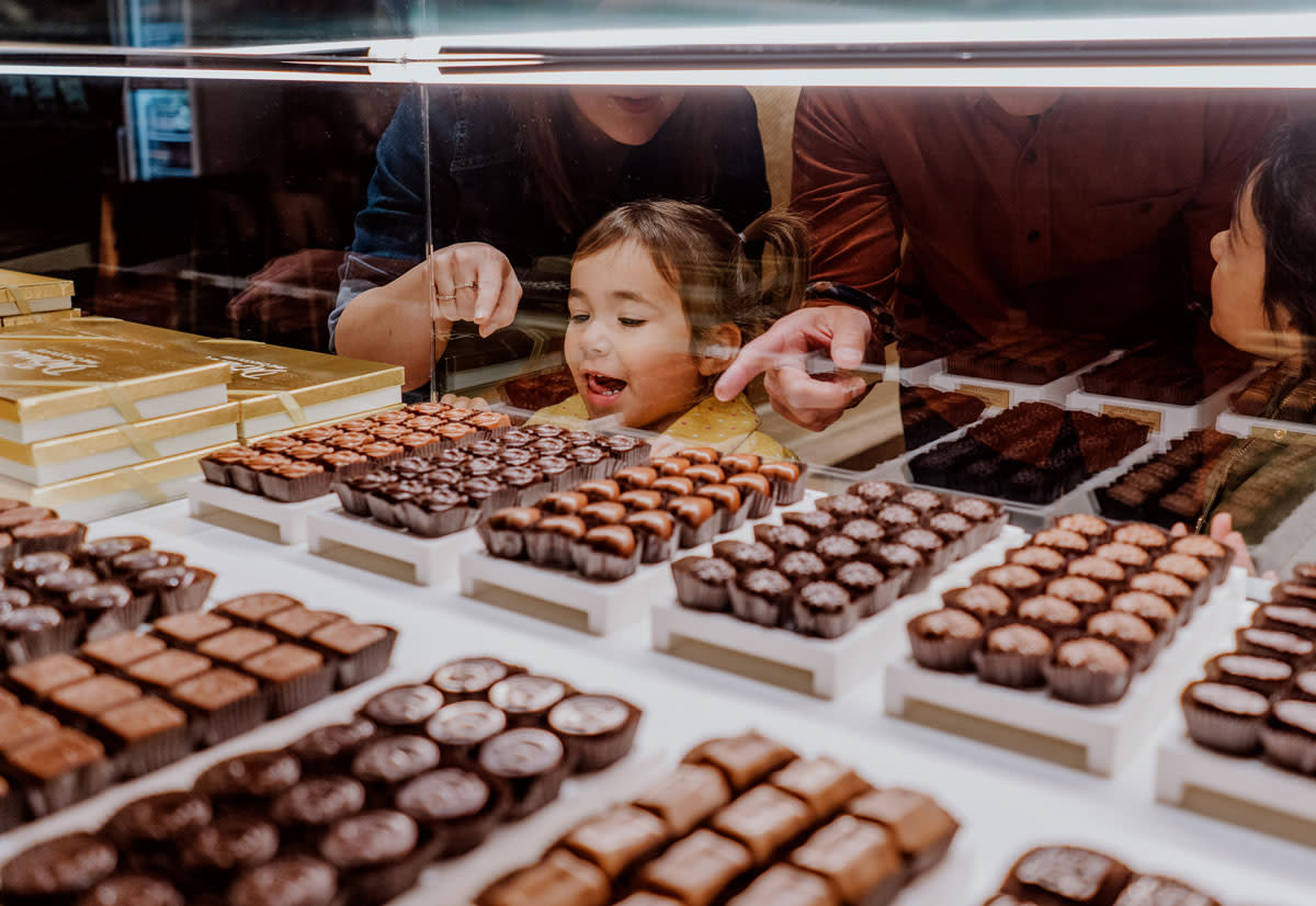 Little girls picking out chocolate at DeBrand Fine Chocolates