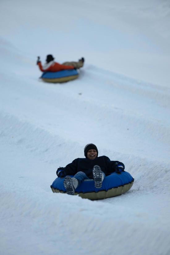 A boy tubing on West Mountain