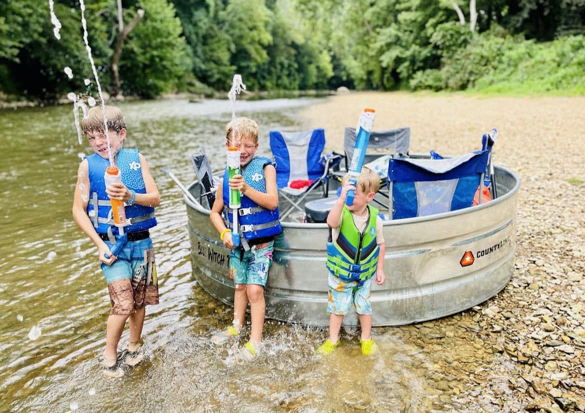 Kids in front of tank on the river.