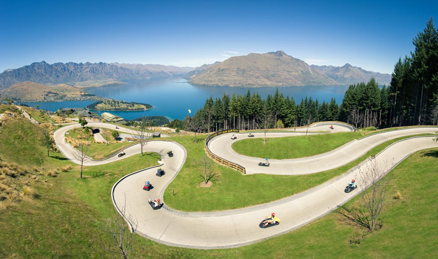 People on the Skyline Queenstown luge with elevated views of Queenstown