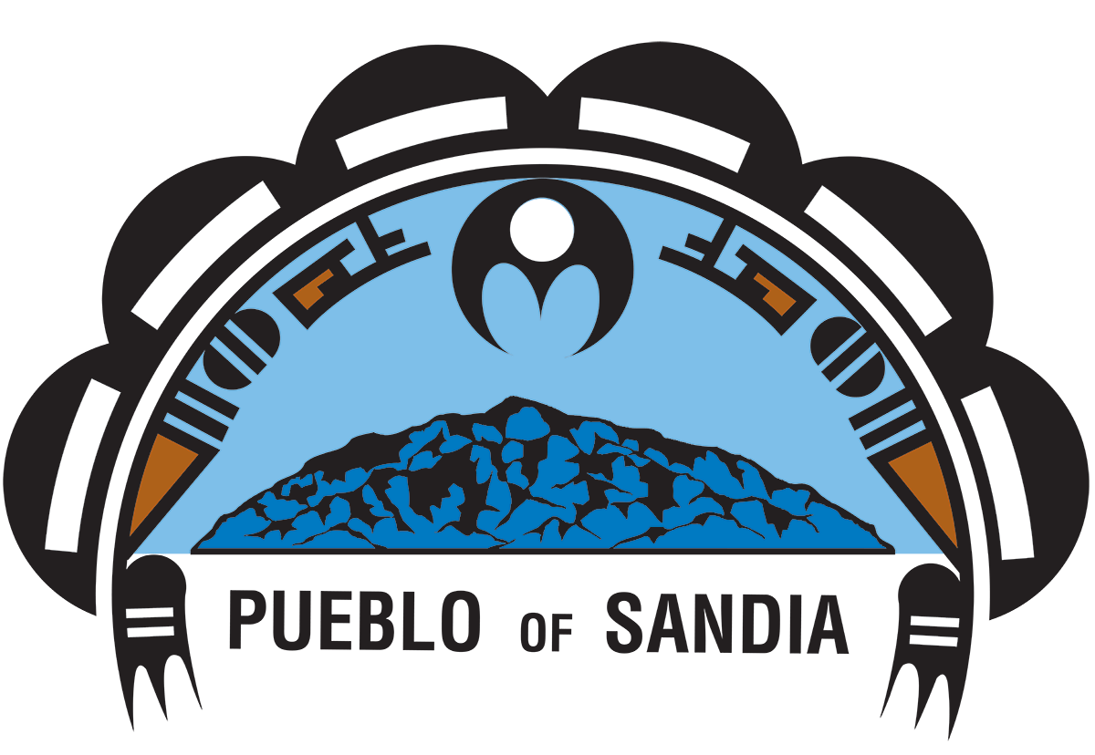 Logo of the Pueblo of Sandia featuring a stylized depiction of a mountain under a blue sky, enclosed within a decorative arch with tribal patterns.