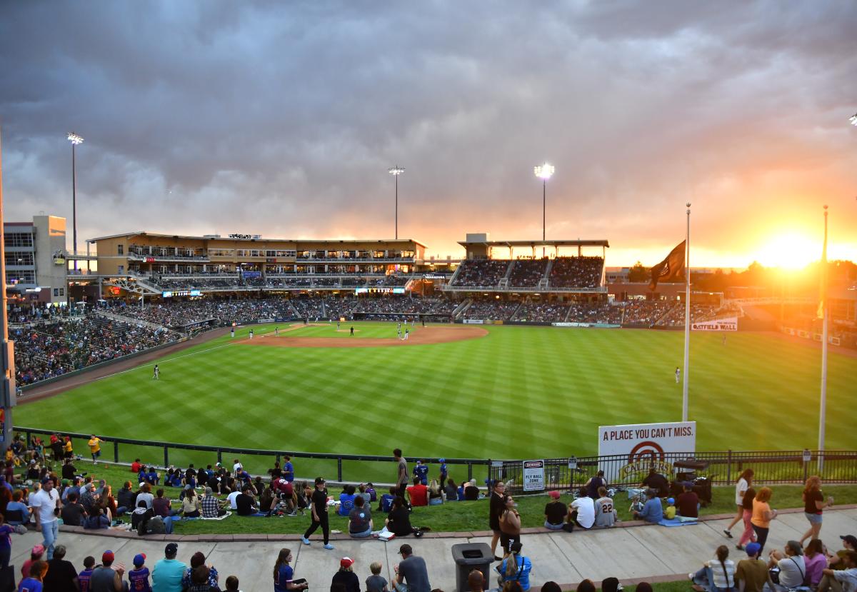 Isotopes Park from the berm area with the sun setting in the background.