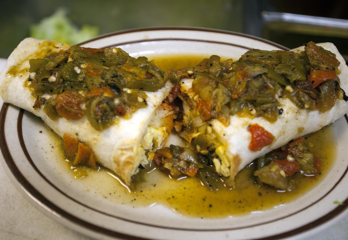 A breakfast burrito topped with fresh-roasted New Mexico hatch chilies.