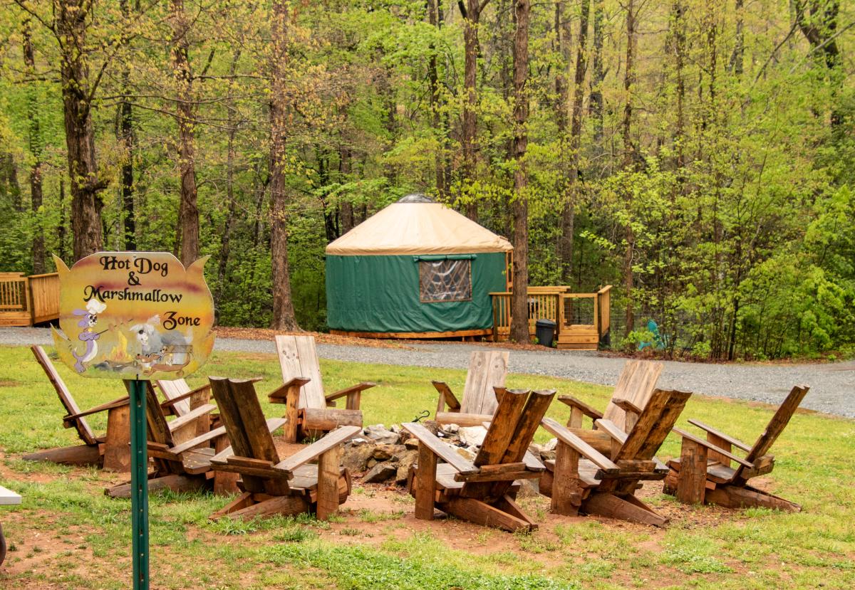 Wood chairs surrounding a fire pit at a campground in Rutherford County, NC.