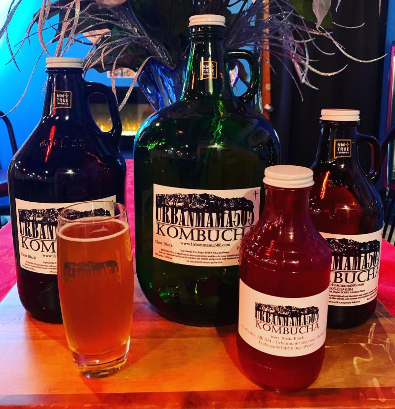 An image of two Urbanmama505 kombucha jugs with two kombucha bottles and a glass of kombucha.
