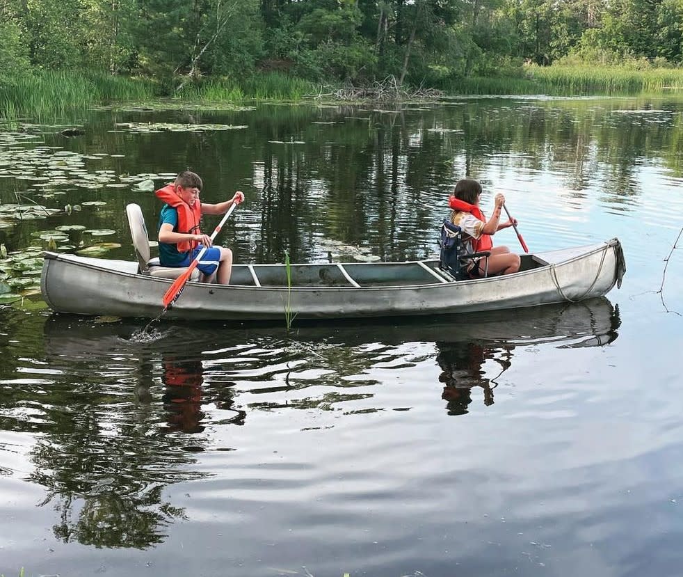 Two children canoeing on Jordan Pond.