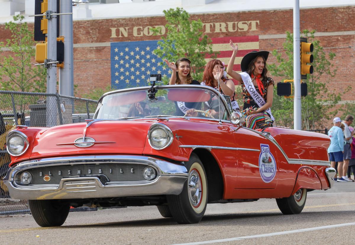 Red Classic Car with Miss Texas Route 66 Pageant Contestants on the Back in the Coors Cowboy Club Cattle Drive and Parade