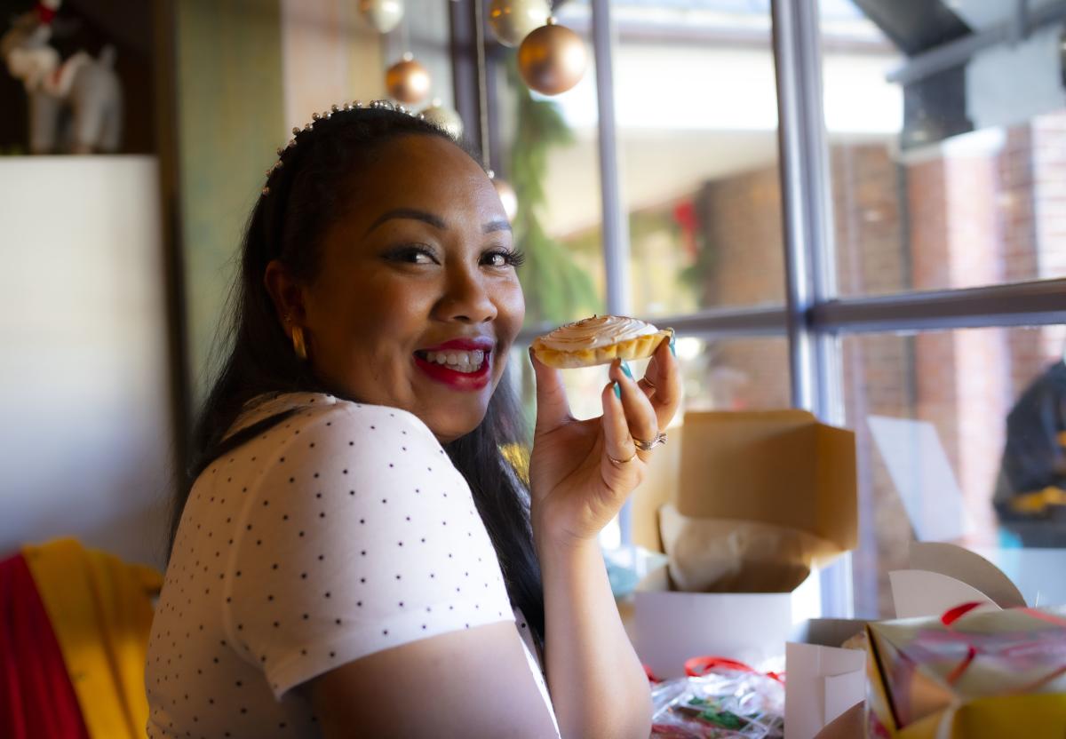 Influencer holding dessert from Aromas Coffeehouse Bakeshop & Cafe