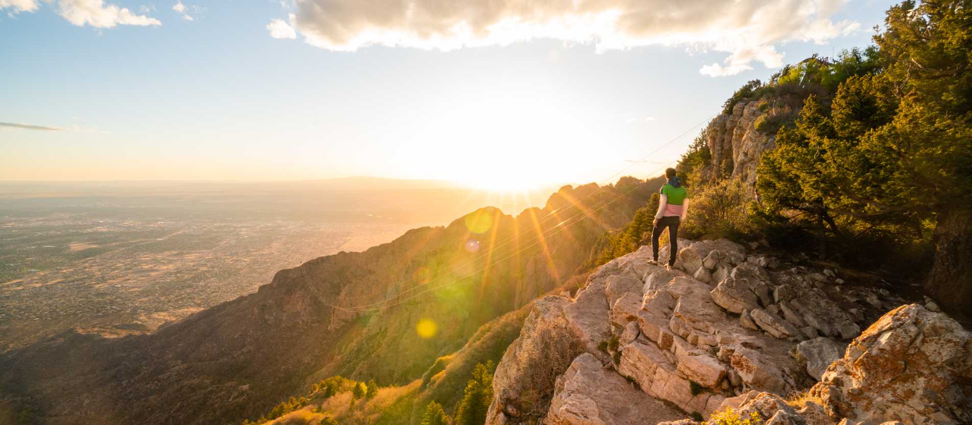 Man hiking in the Sandia Mountains in bright colored clothing