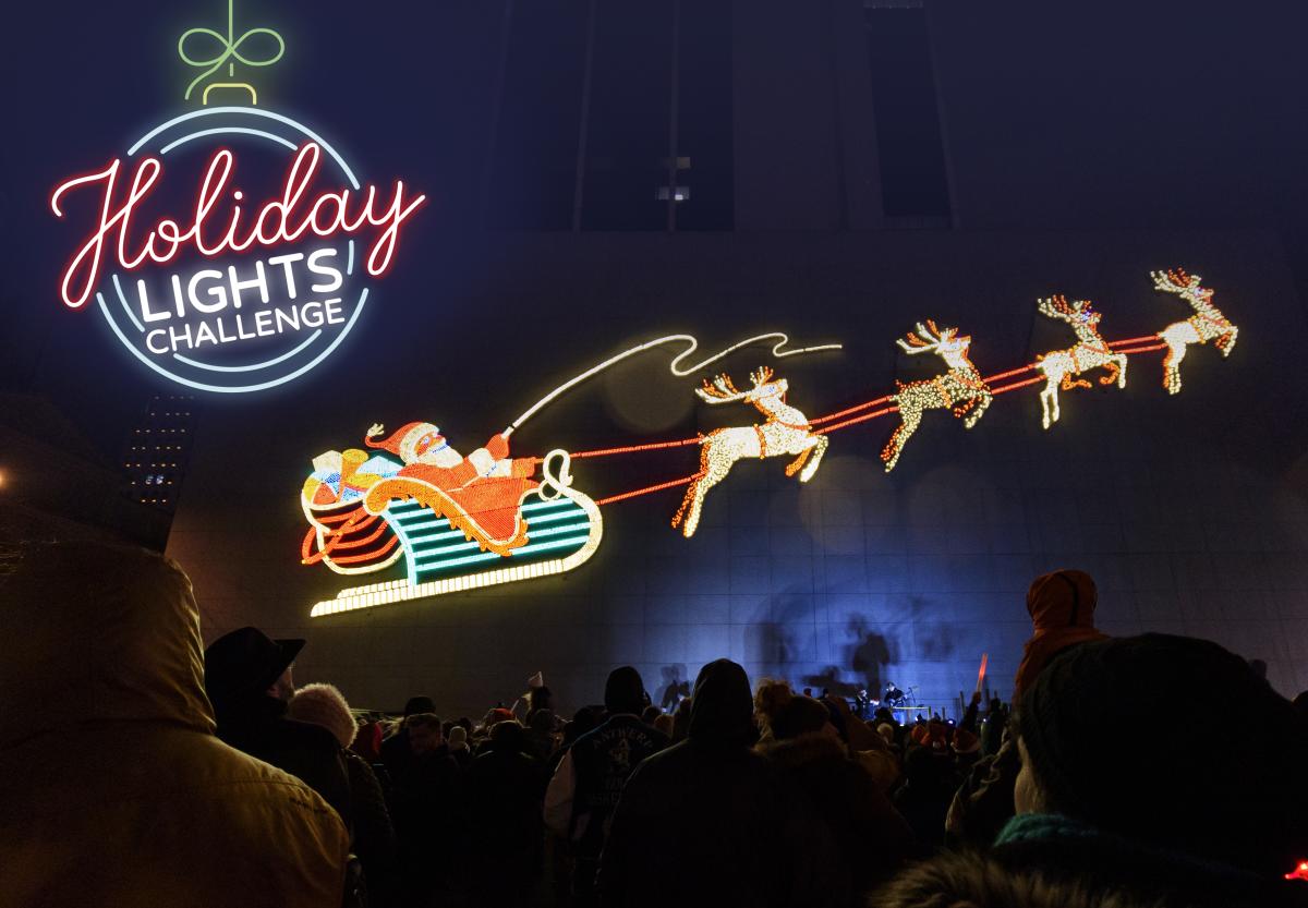 santa and his reindeer holiday lights display at night