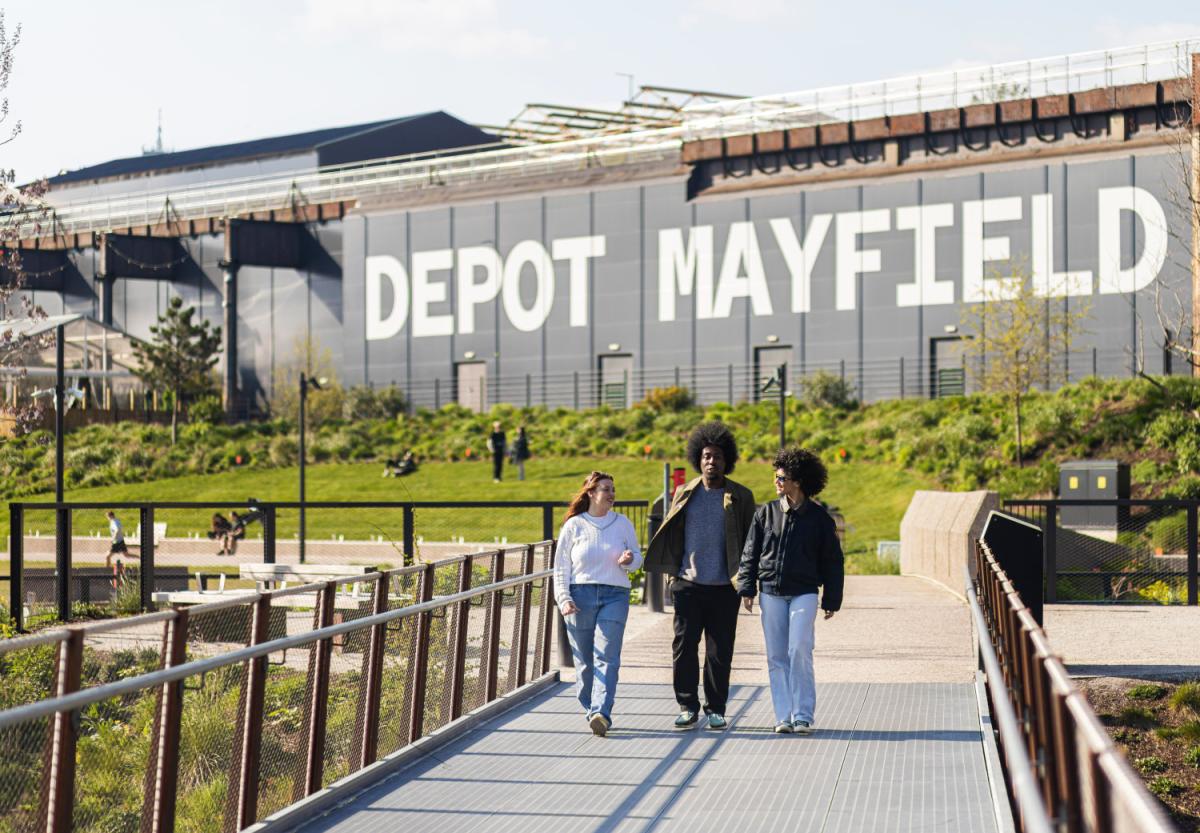 Friends walking along a path at Depot Mayfield