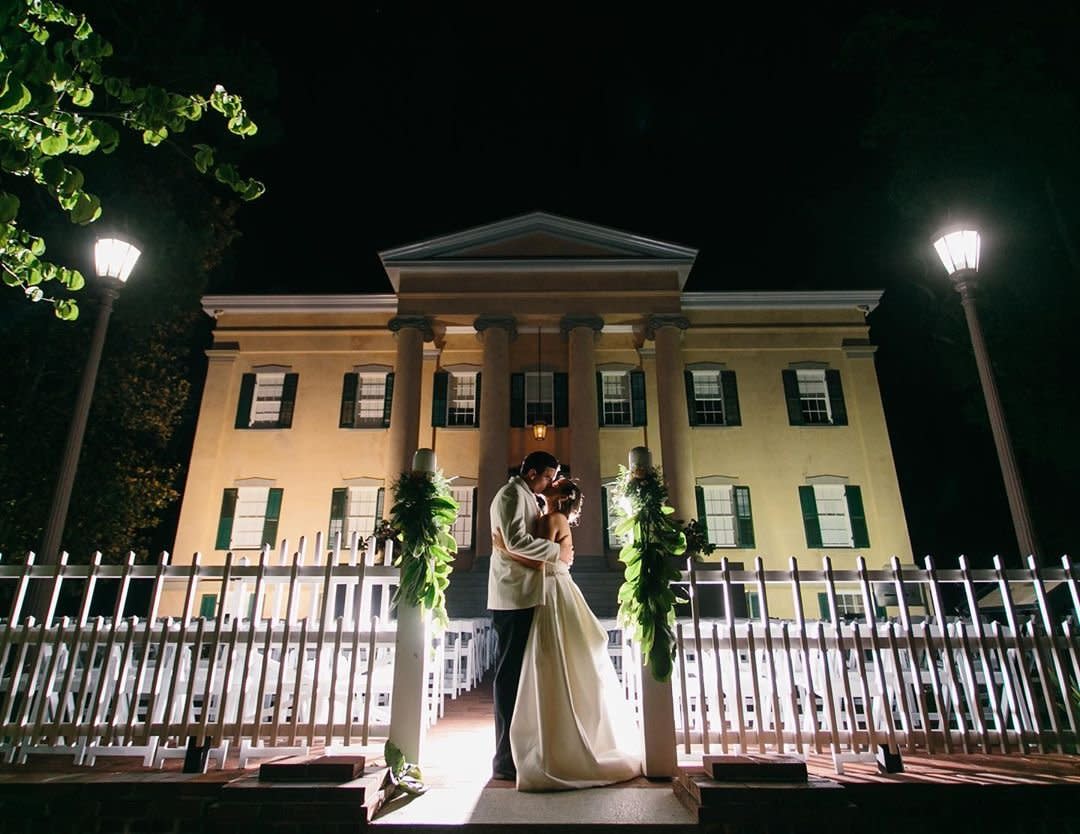 Bride and Groom Kissing At Night In Front Of Georgia's Old Governor's Mansion